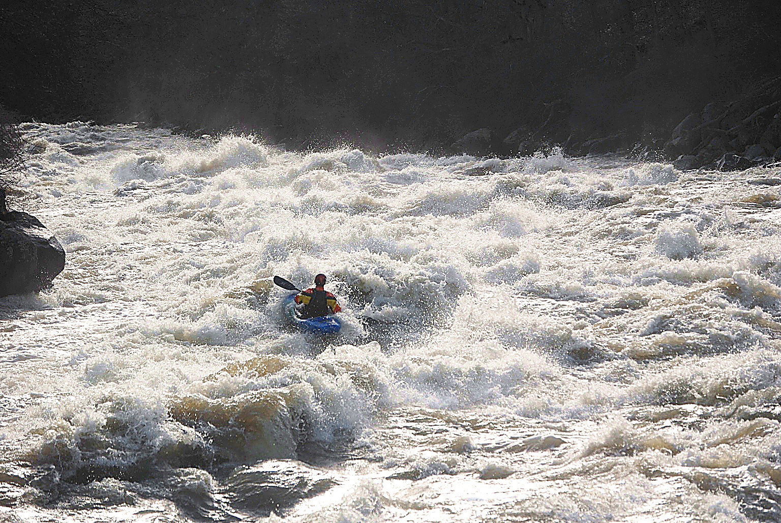 Kayaker paddling high water river Klamath River