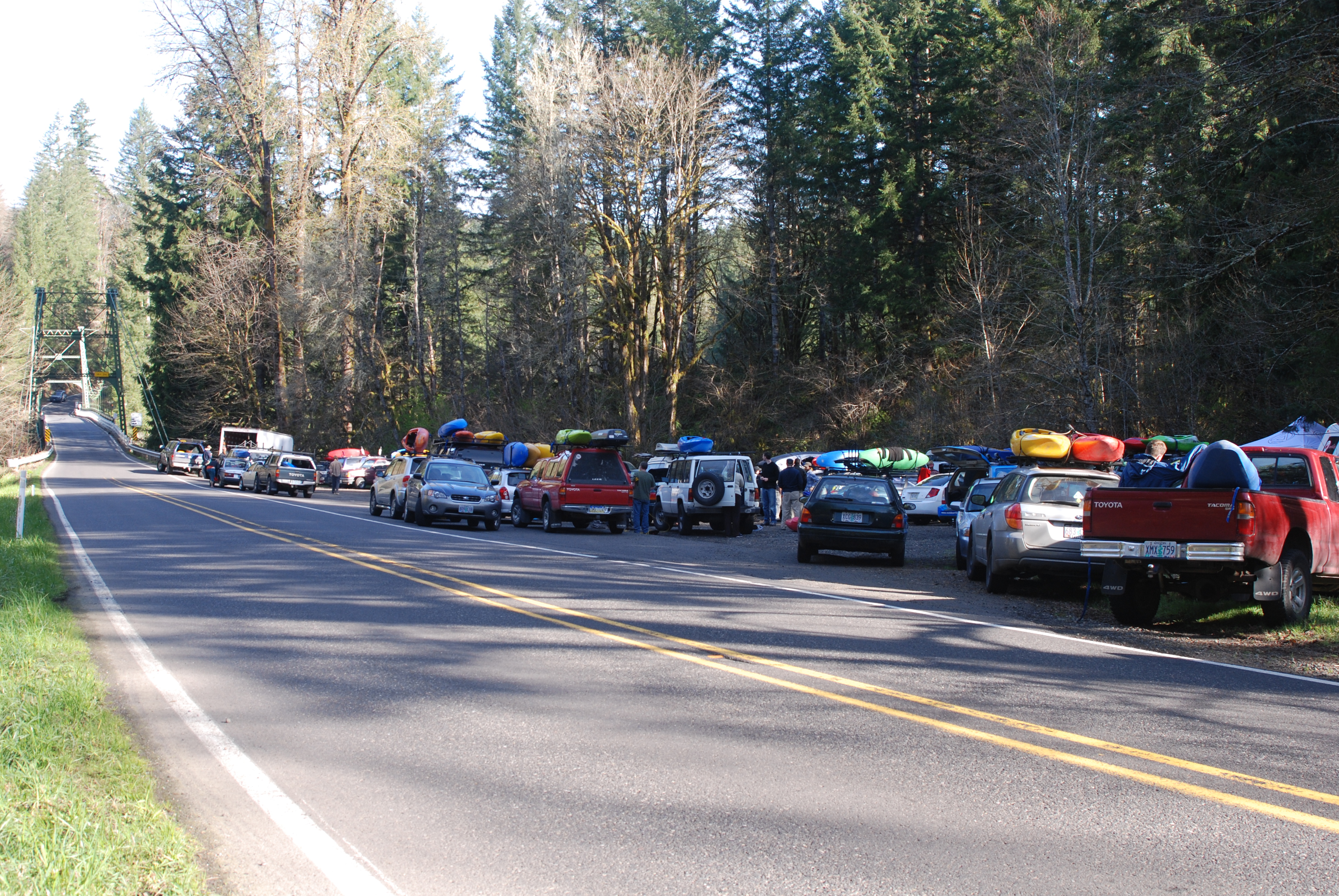 Yale Bridge Access take-out on Canyon Creek with parked cars and boats near the bridge.