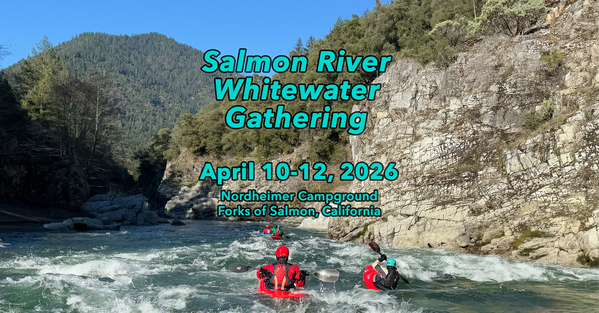 Kayakers on whitewater with mountains in view