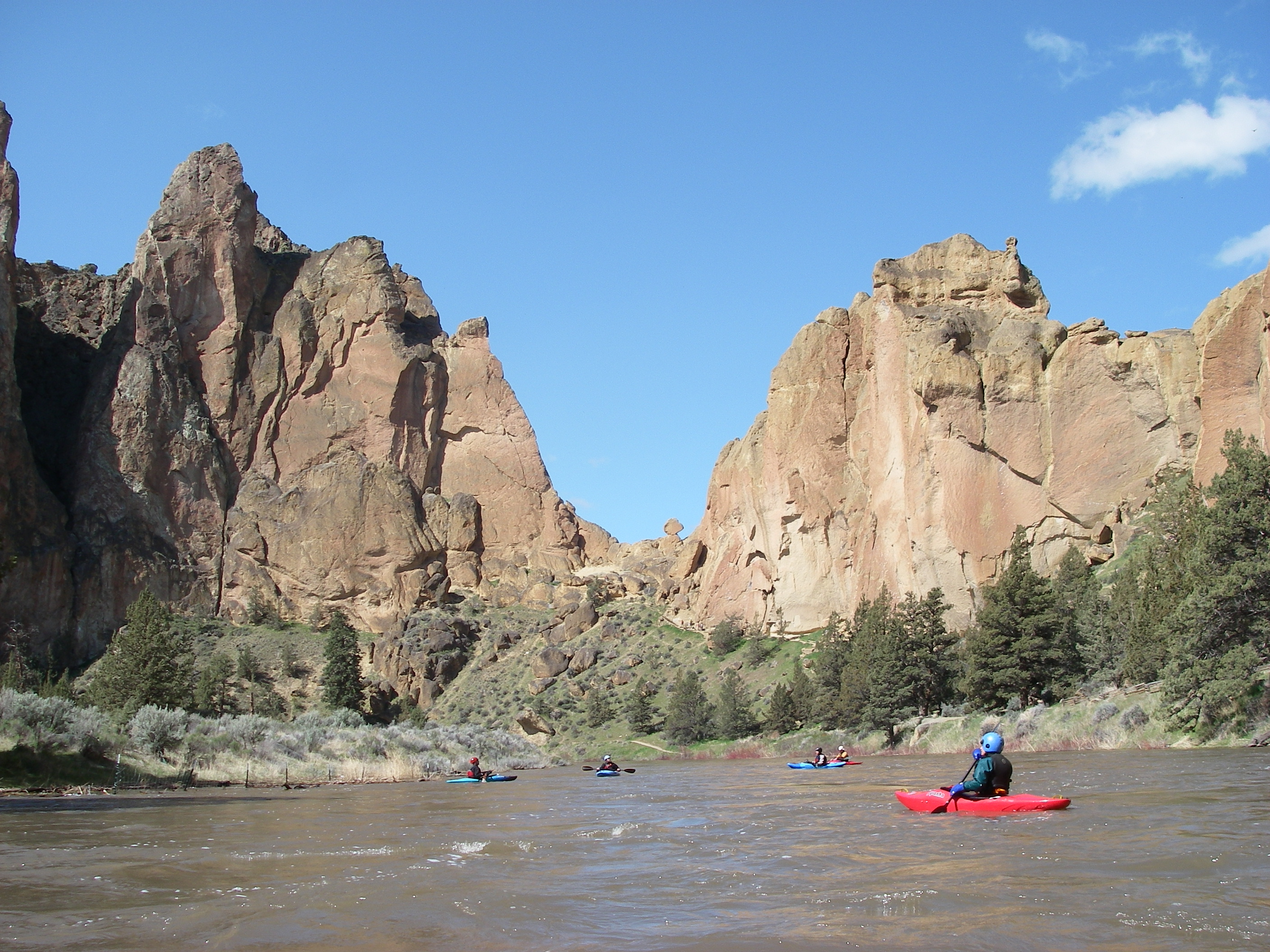 Kayakers floating on the Crooked River through Smith Rock State Park.